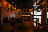 a dimly lit restaurant with tables and chairs