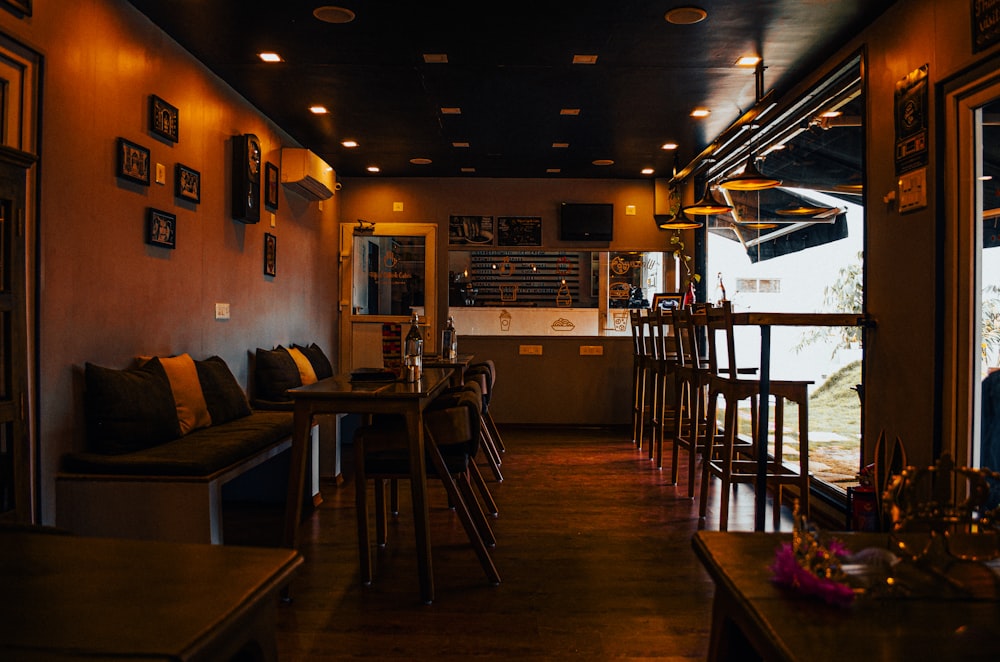 a dimly lit restaurant with tables and chairs