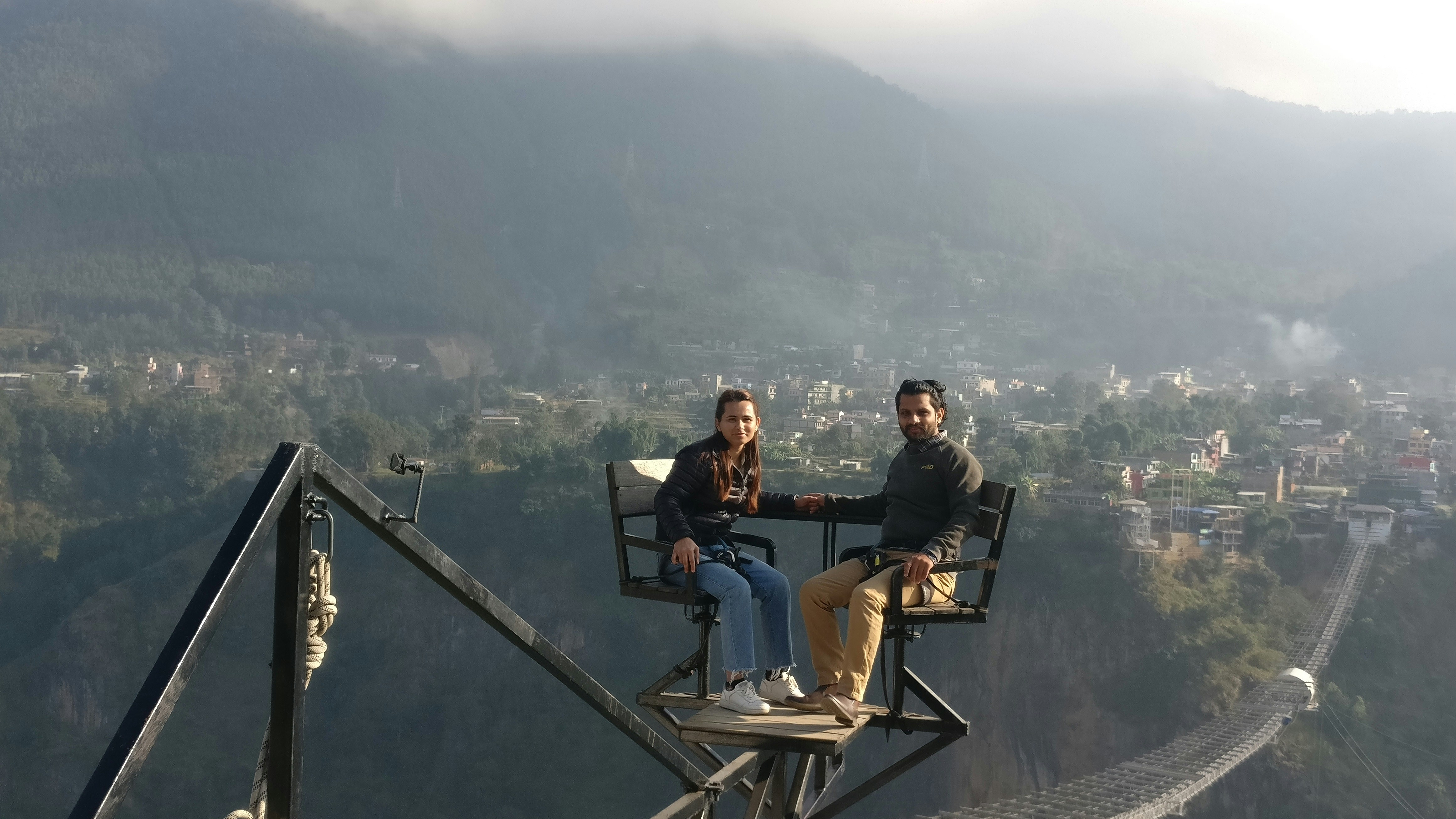 a couple of people sitting on top of a chair