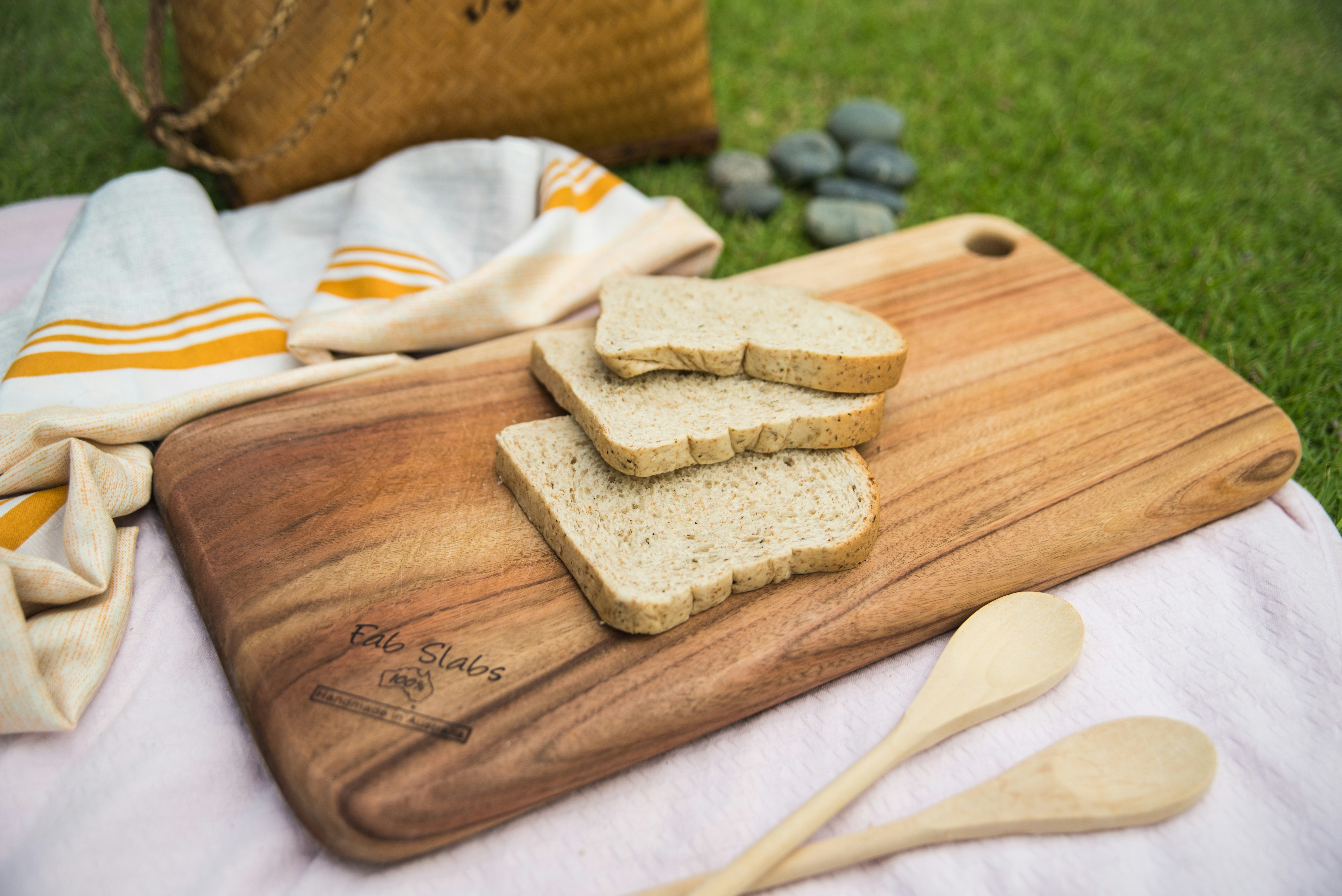 A wooden cutting board topped with slices of bread photo Free Wooden