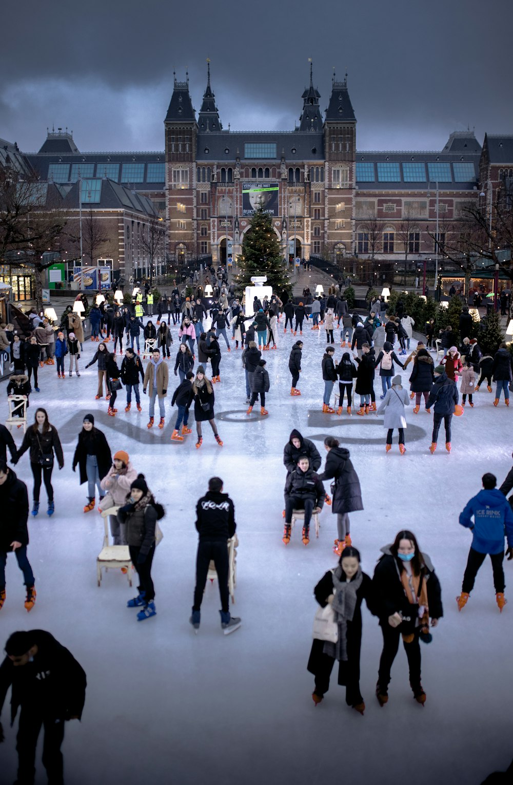 a group of people skating on an ice rink