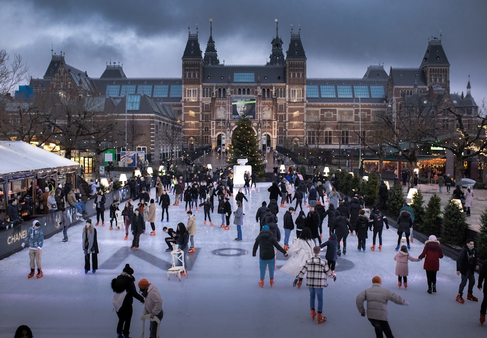 a group of people skating on an ice rink