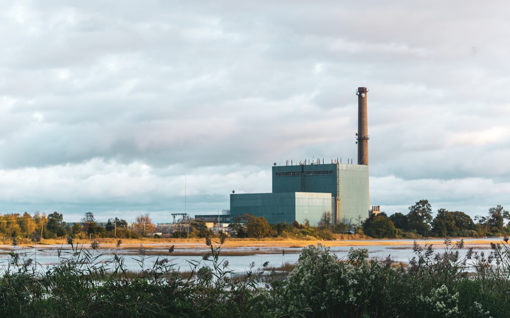 a factory with a body of water in front of it