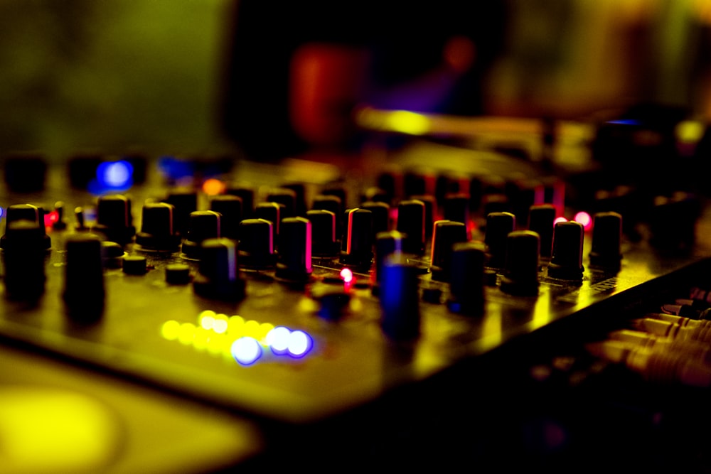 a close up of a sound board with many knobs