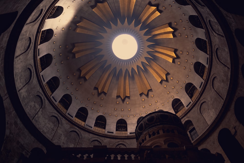 a large clock mounted to the side with Church of the Holy Sepulchre in the background