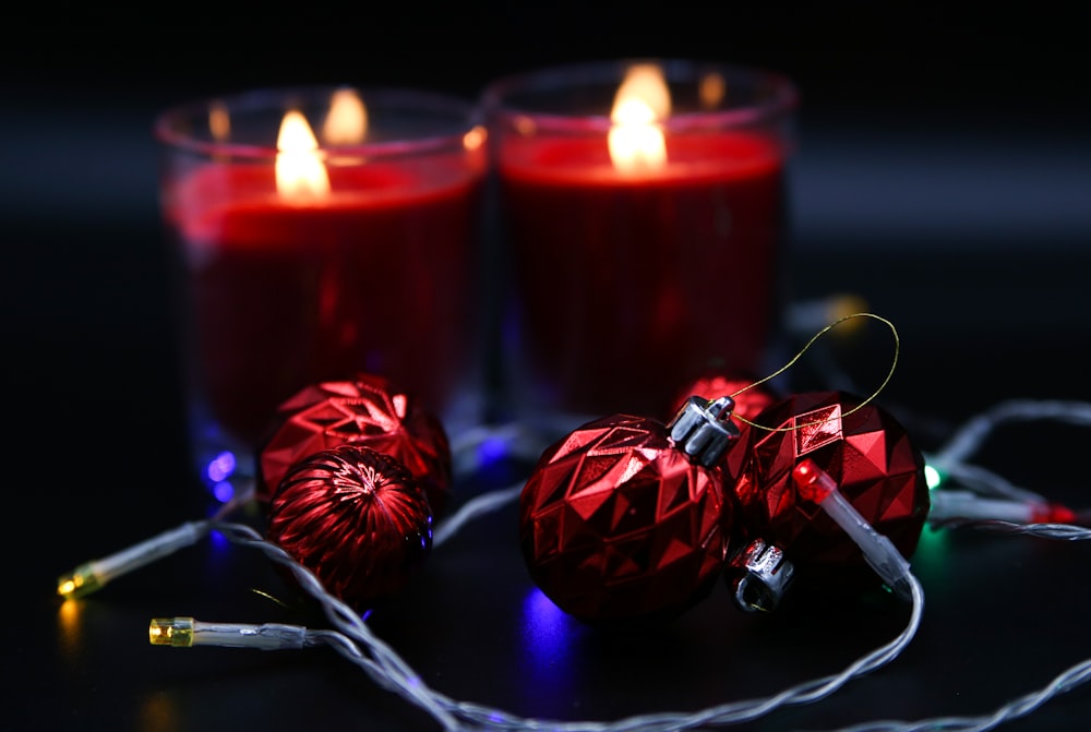 a couple of red candles sitting next to each other