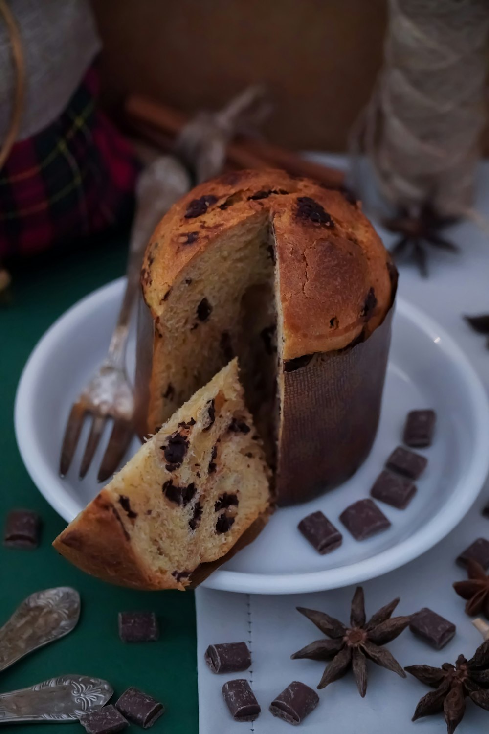 a chocolate chip muffin cut in half on a plate