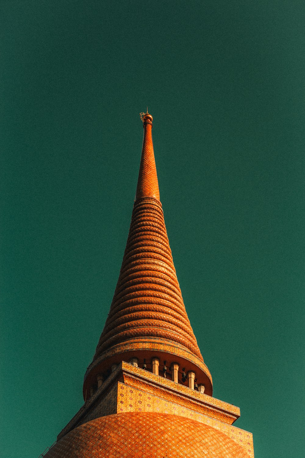 a very tall tower with a clock on it's side