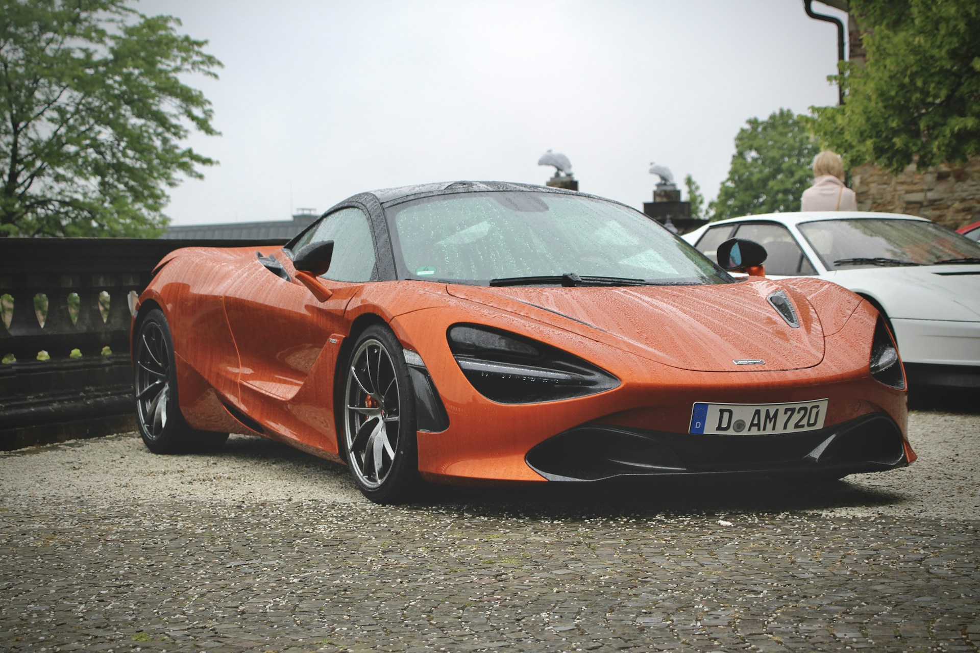 an orange sports car parked in a parking lot