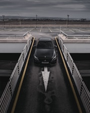 a black car is parked in a parking lot
