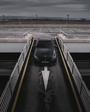 a black car is parked in a parking lot