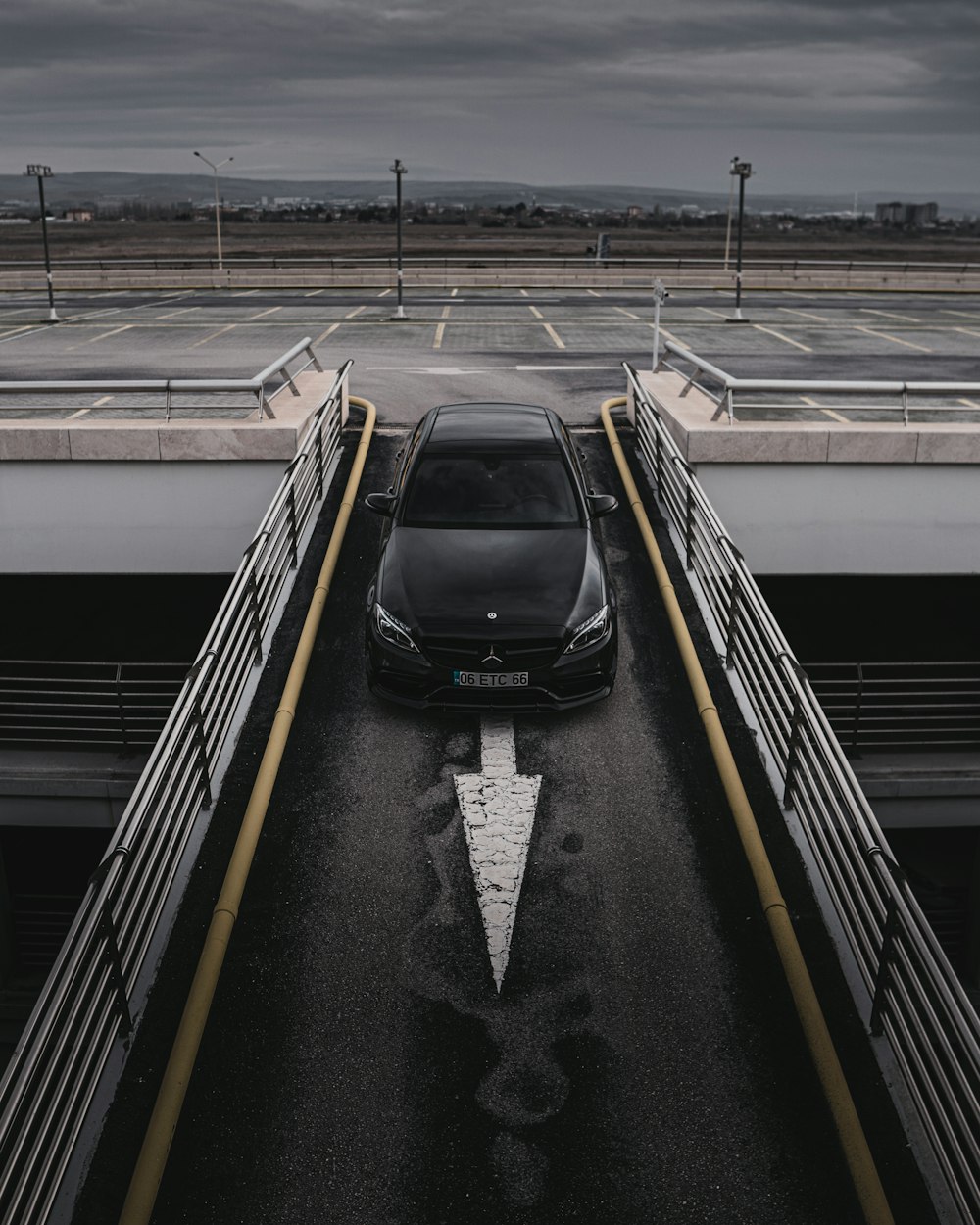 a black car is parked in a parking lot