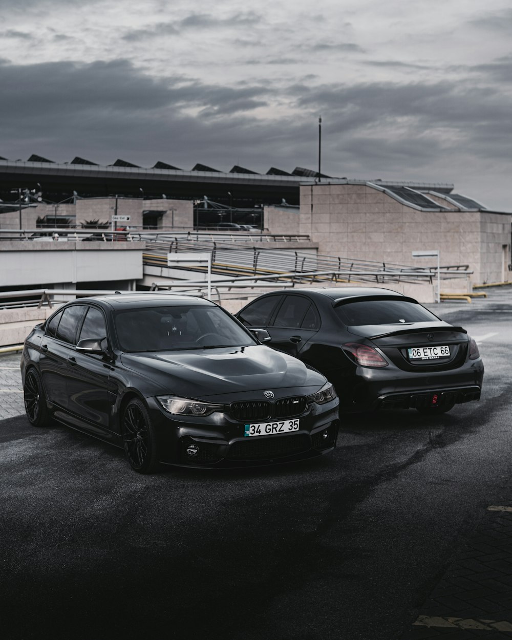 two cars parked next to each other in a parking lot