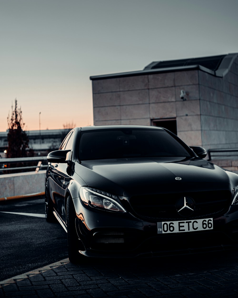 a black car parked in front of a building