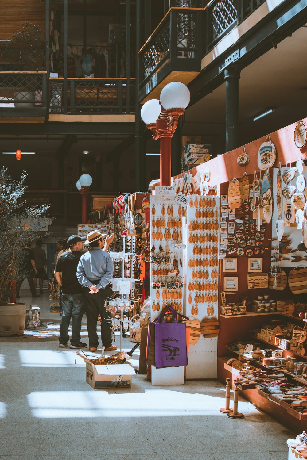 a couple of men standing next to each other in a store