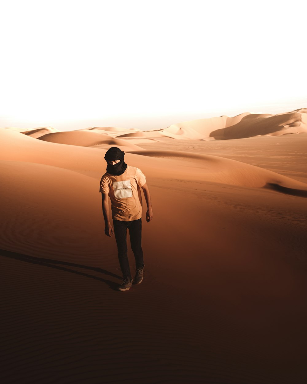 a man standing in the middle of a desert