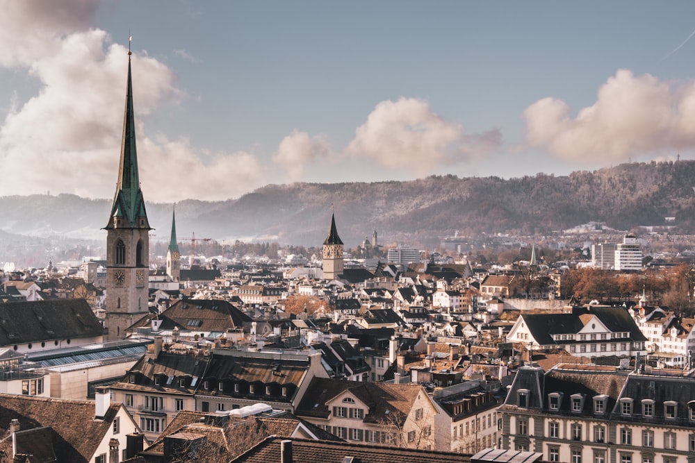 a view of a city with a steeple in the background