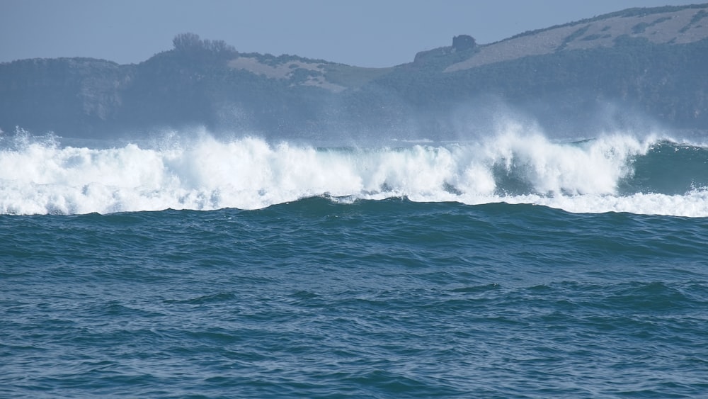 a large body of water with a wave coming in