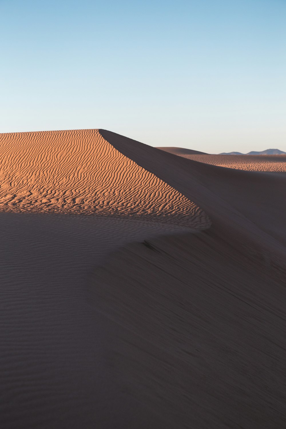 a large sand dune in the middle of a desert