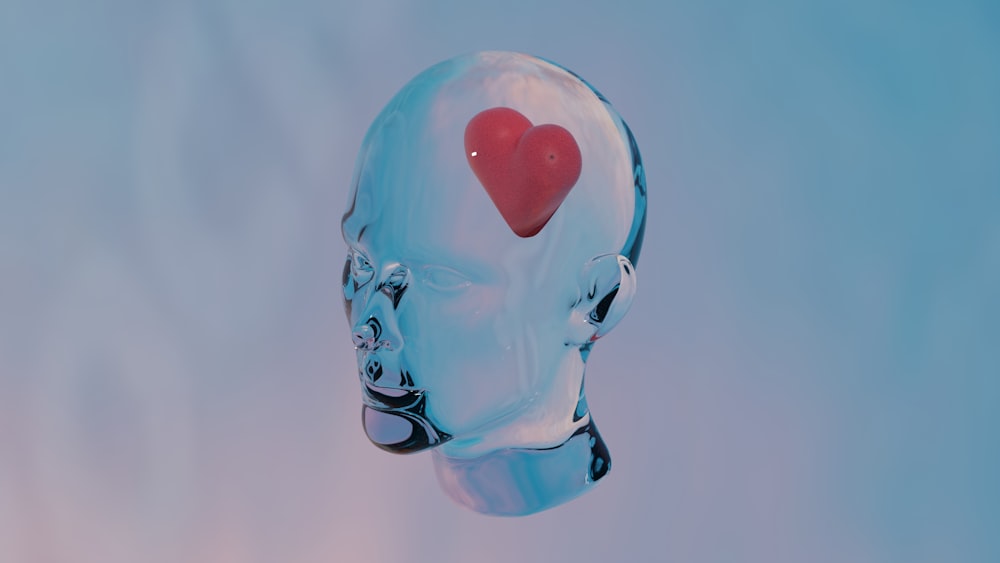 a glass head with a red heart in the middle of it