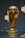 A golden trophy is displayed, featuring intricate sculpted details and a globe at the top. It is set on a dark background with reflective surfaces around it.