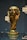 A golden trophy is displayed, featuring intricate sculpted details and a globe at the top. It is set on a dark background with reflective surfaces around it.