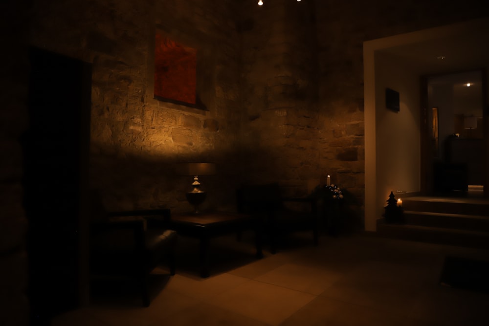 a dimly lit room with a painting on the wall