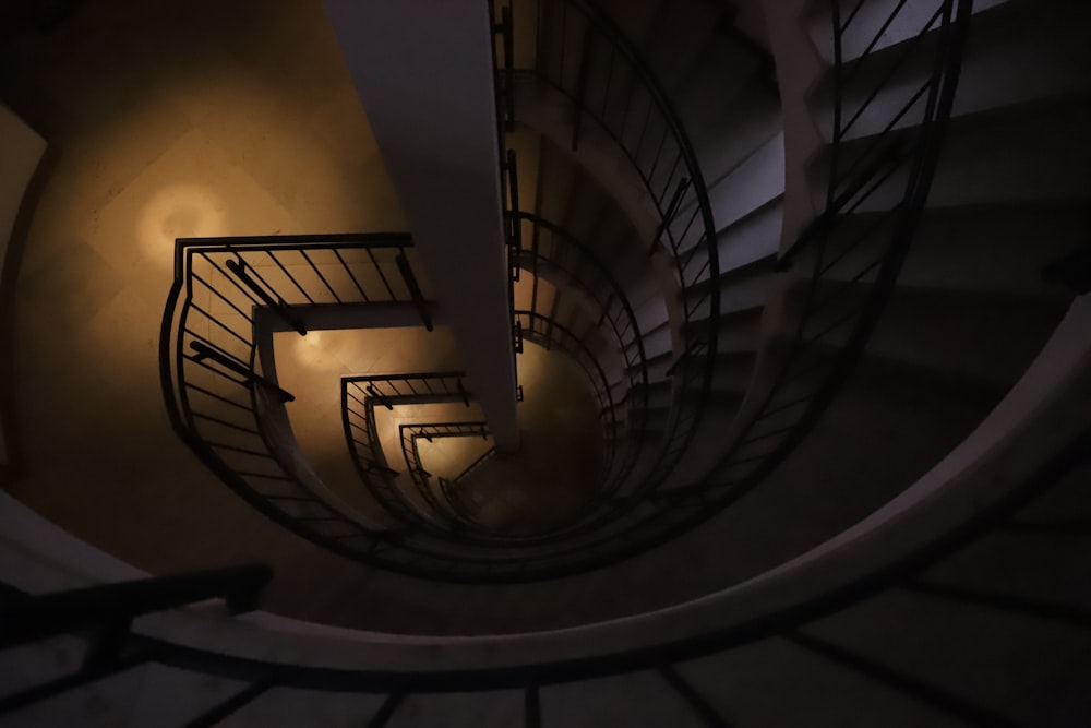 a spiral staircase with a light at the end