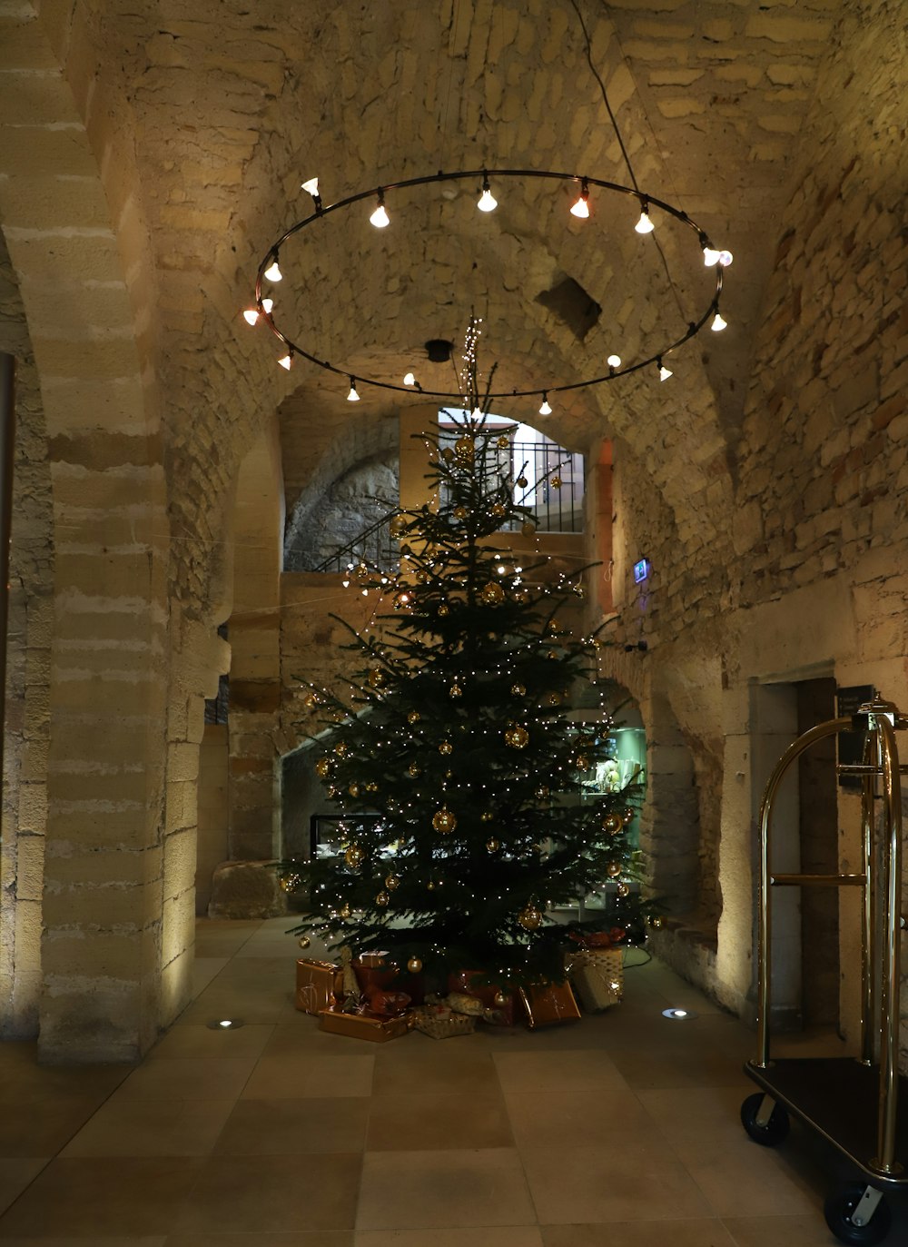 a large christmas tree in a stone building