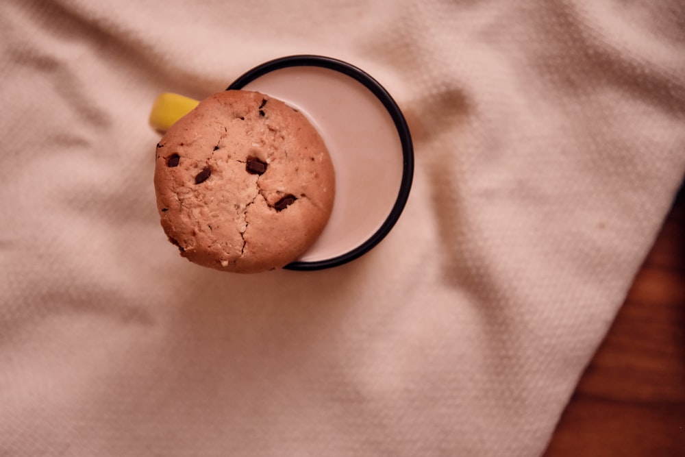 a chocolate chip cookie in a mug on a table