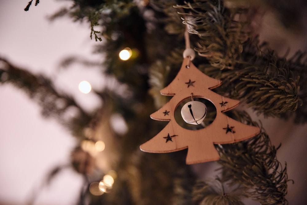 a wooden ornament hanging from a christmas tree