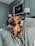 a dog sitting on top of a blanket on a couch