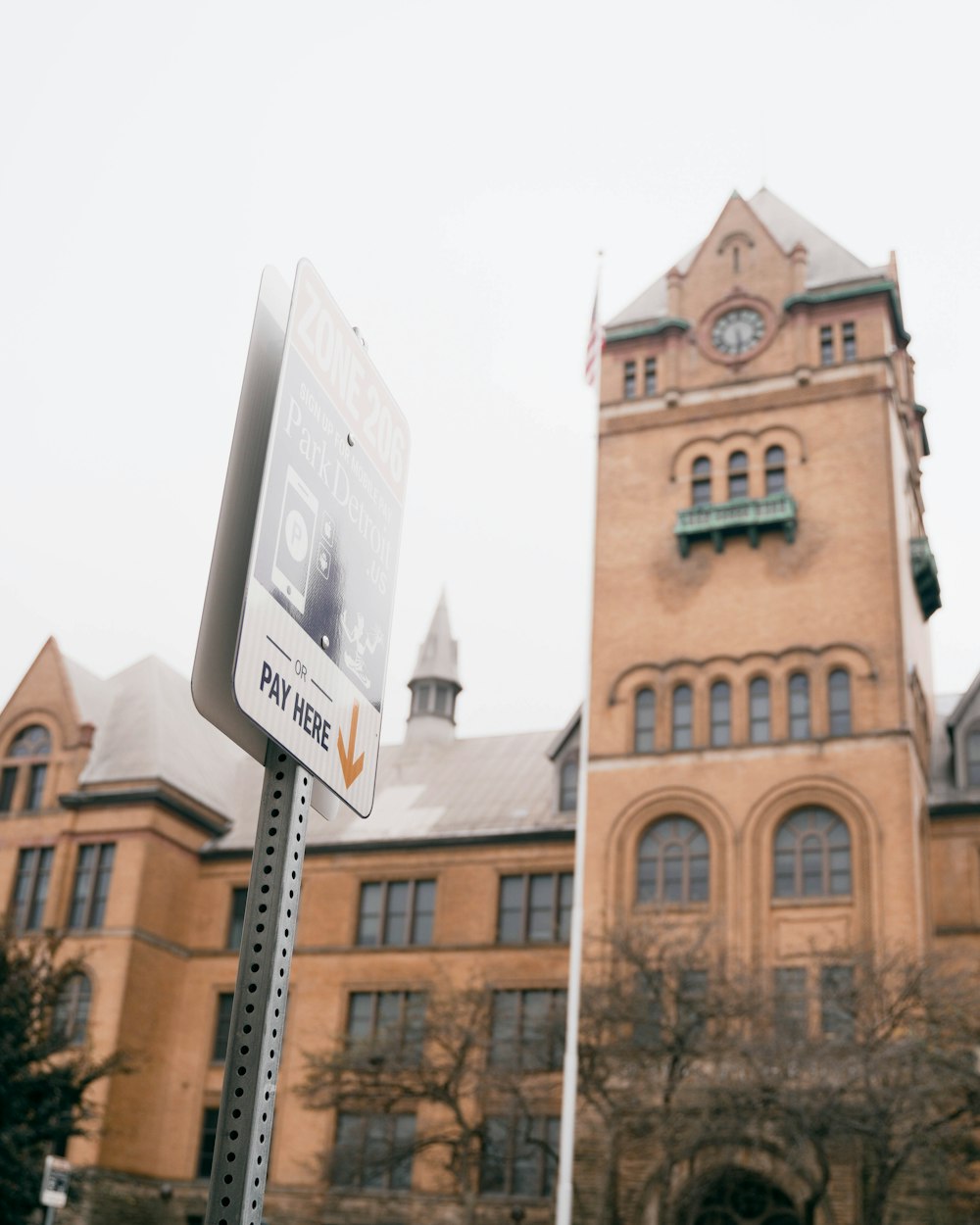 a street sign in front of a large building