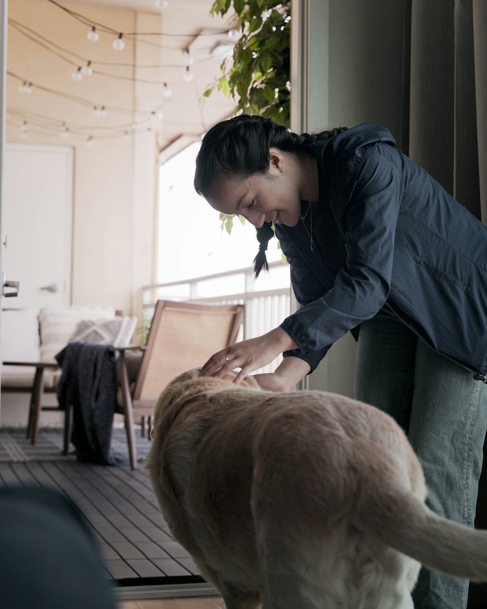 a woman petting a dog on the nose