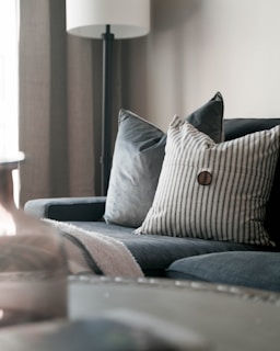 a living room with a couch and a lamp