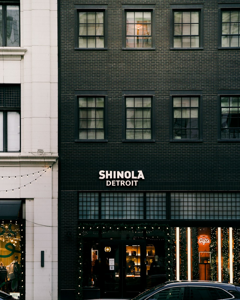 a couple of cars parked in front of a building