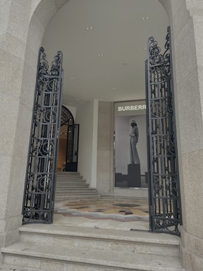 Elegant black and gold luxury real estate office entrance at dusk