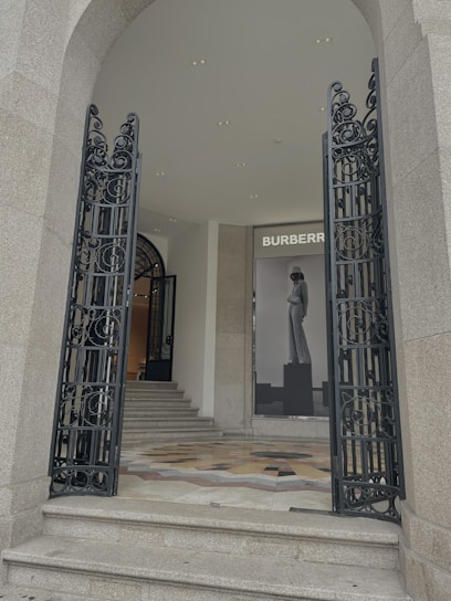 Luxurious office entrance with black marble and golden accents, reflecting elegance.