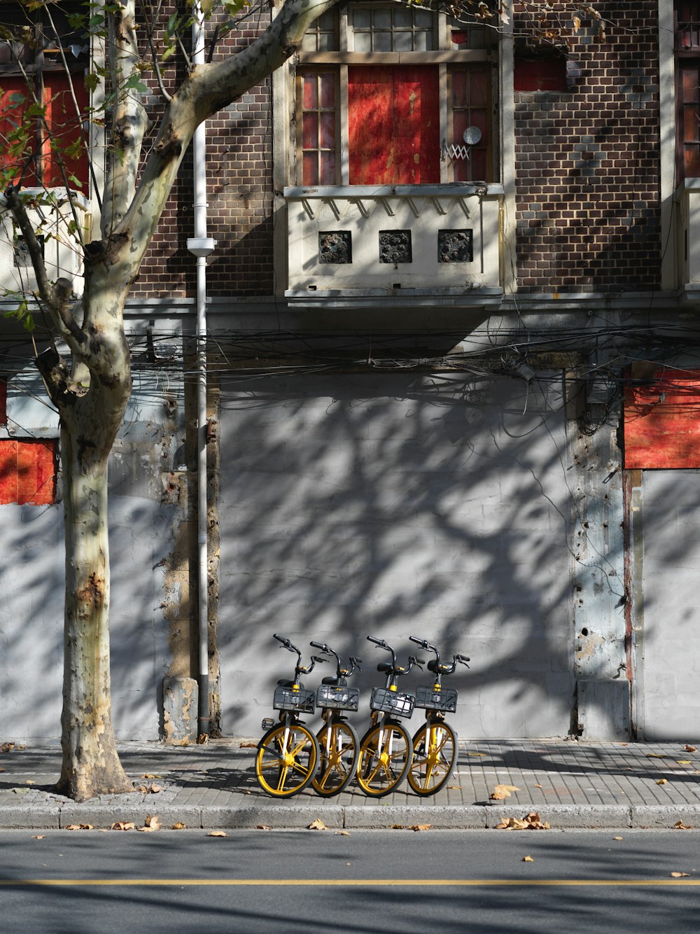 three bicycles parked on the side of the road