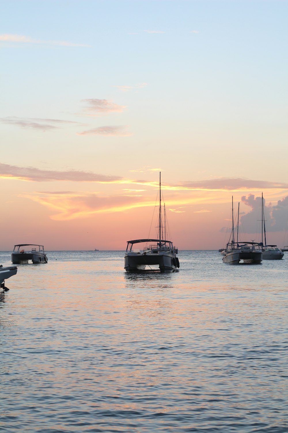 a group of boats floating on top of a body of water