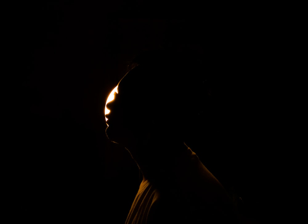 a silhouette of a person in the dark