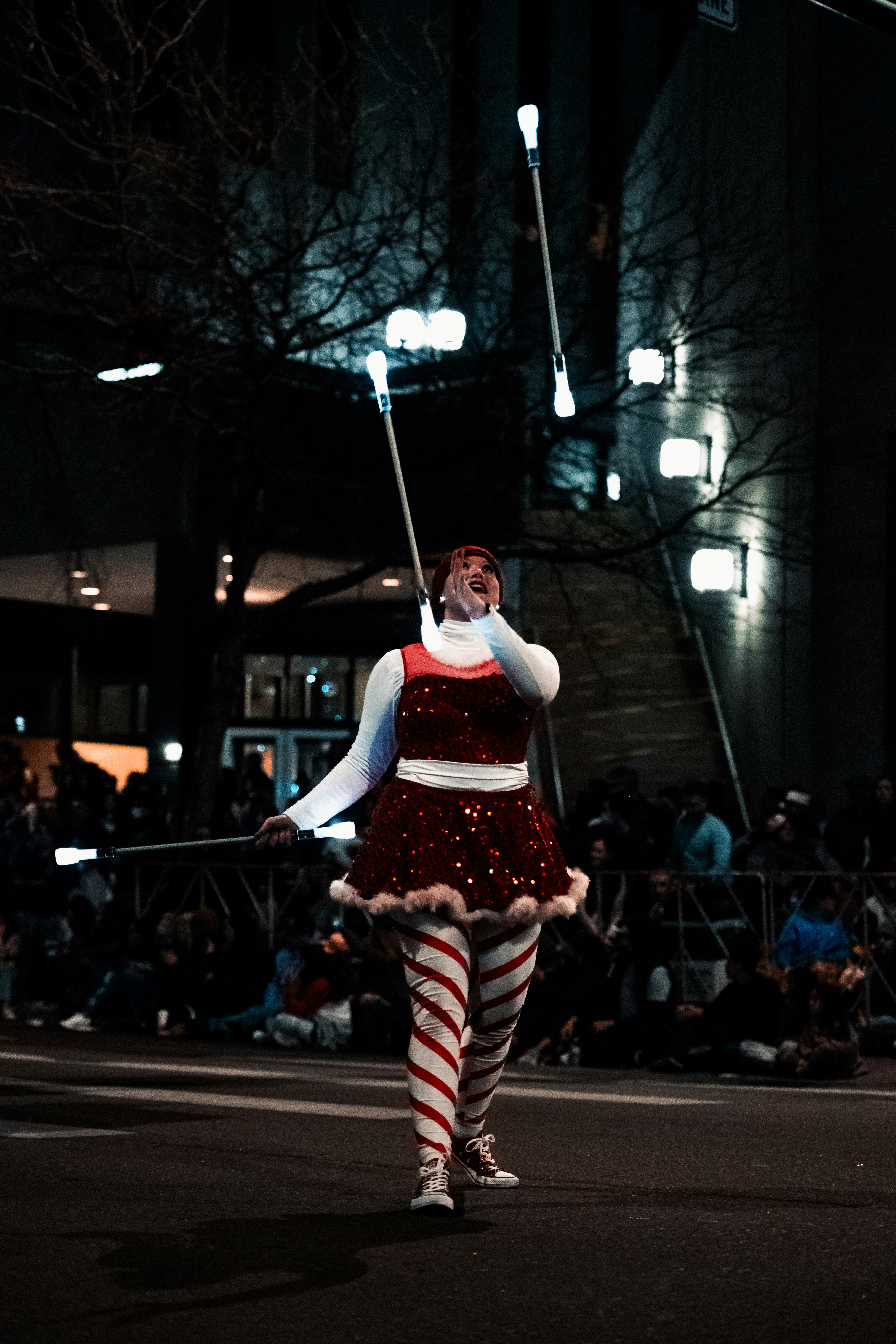 a woman in a red and white striped dress is walking down the street