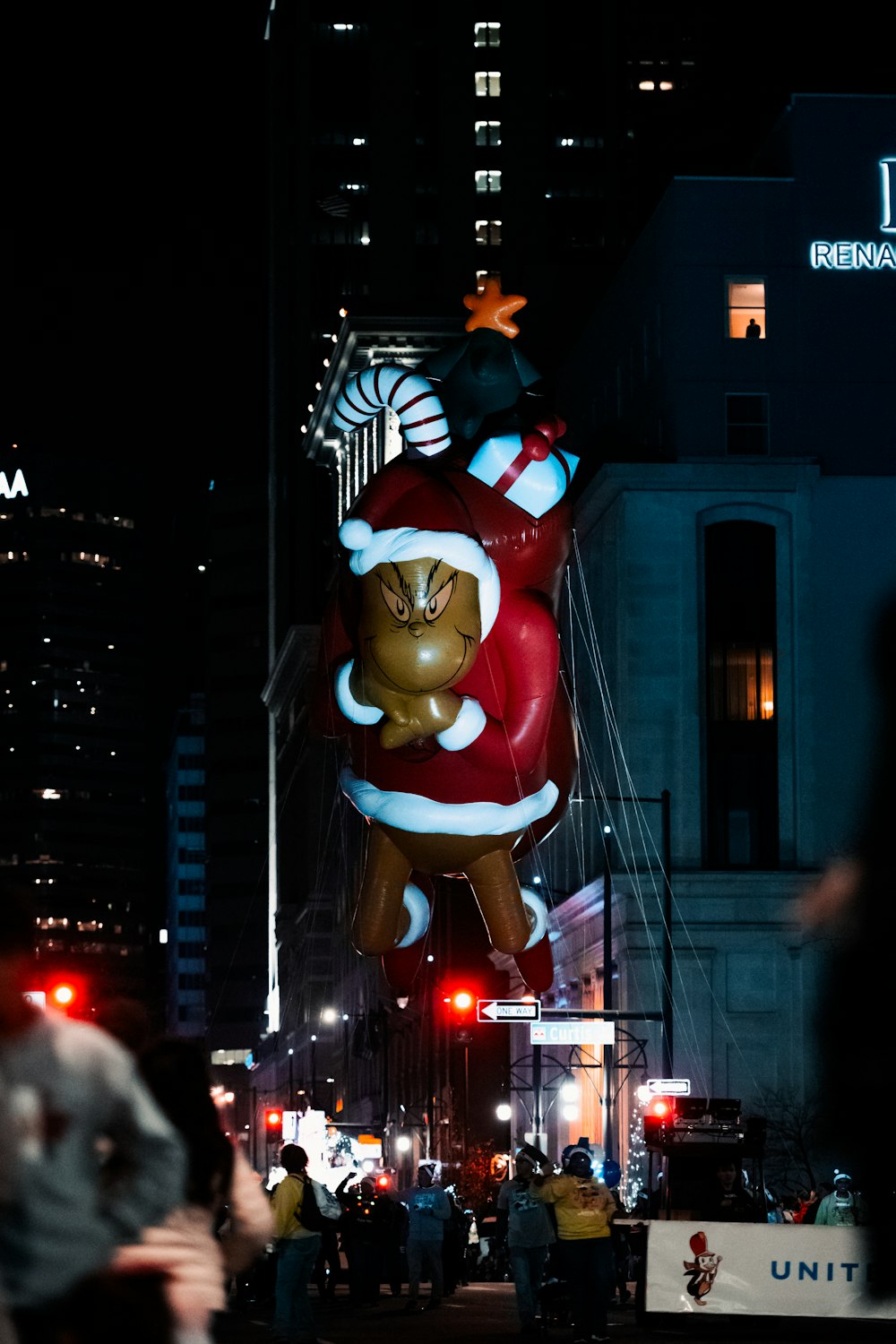 a large christmas balloon in the middle of a city street