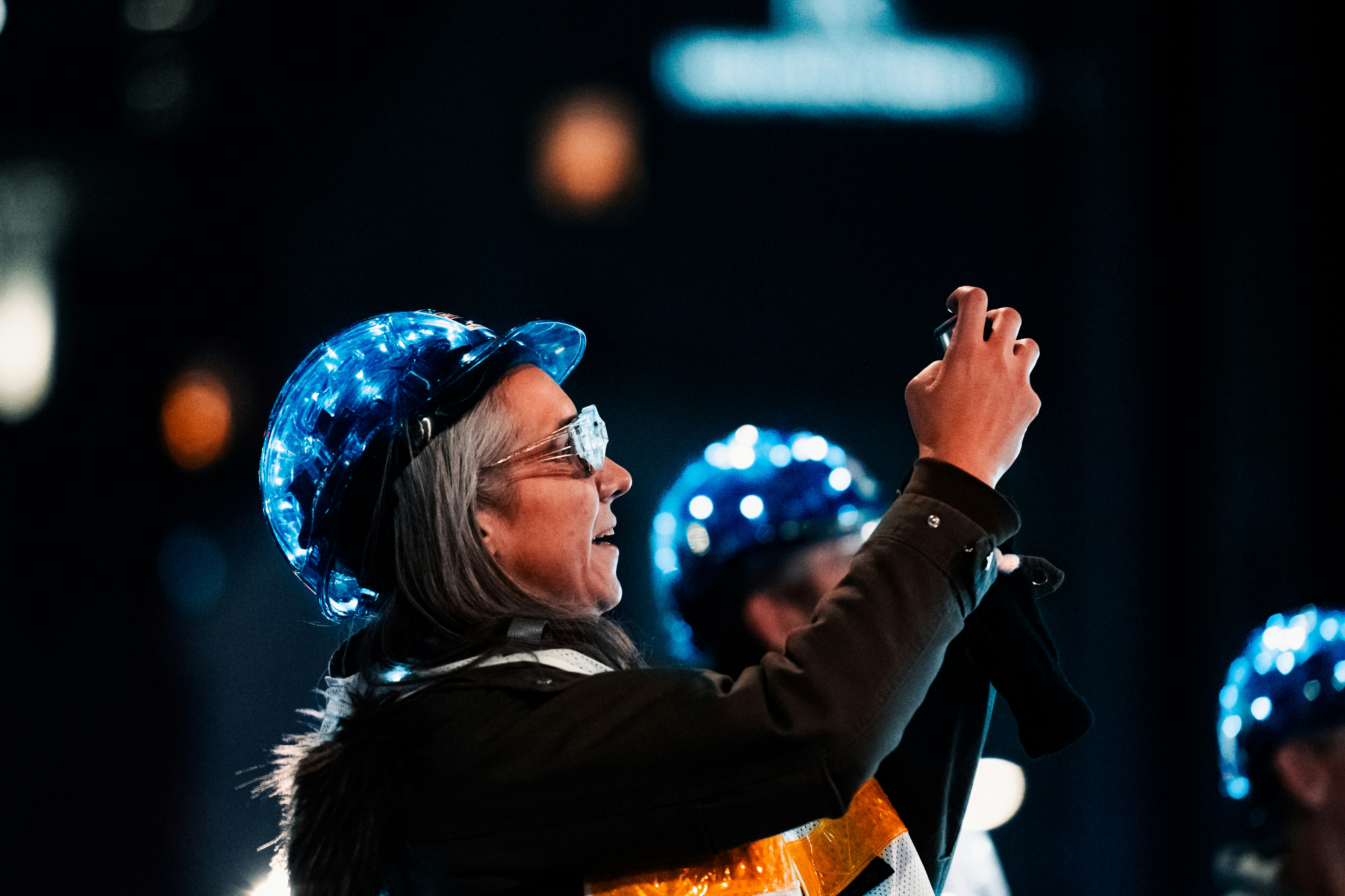 a woman wearing a blue hat and holding a microphone