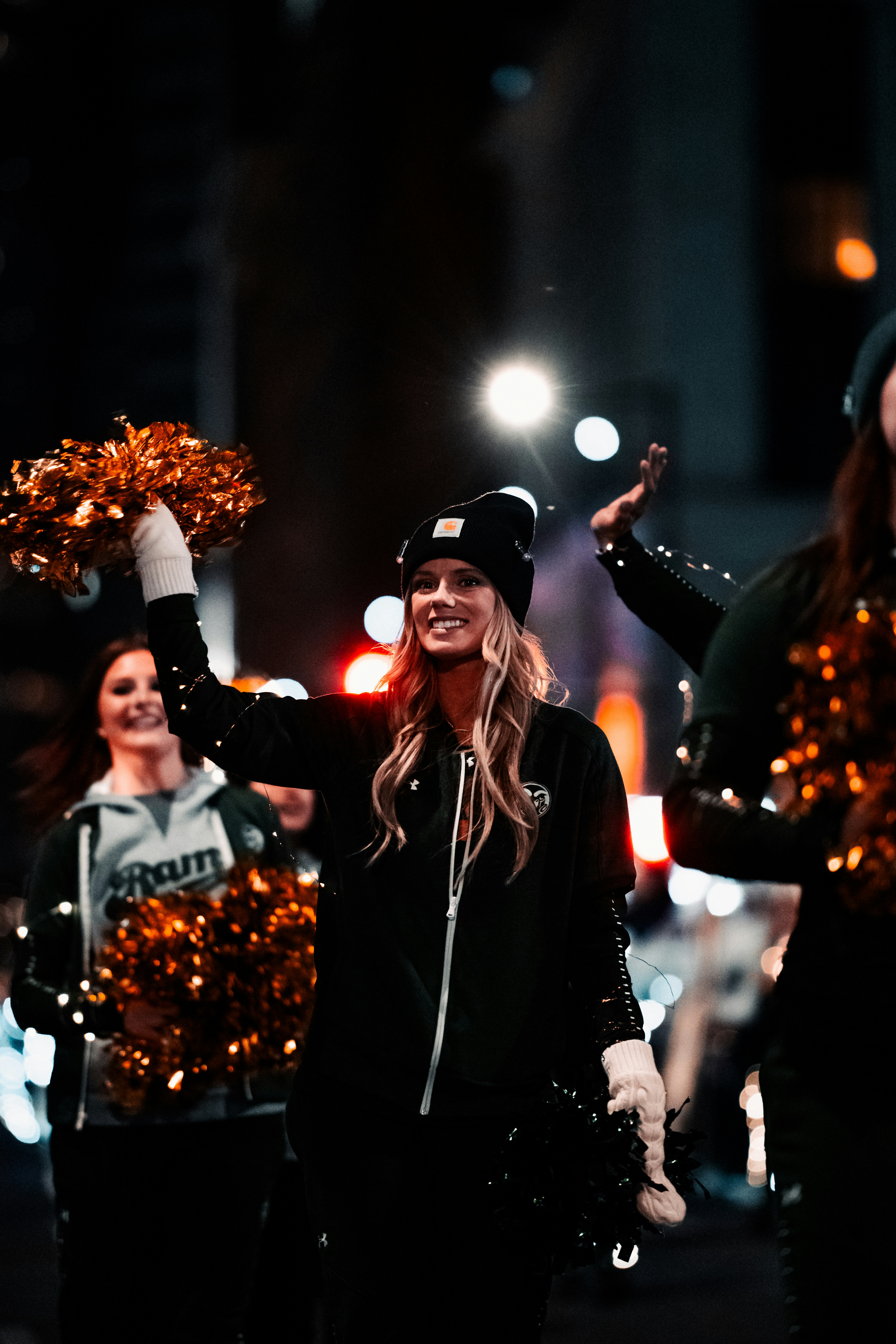 a group of cheerleaders walking down the street