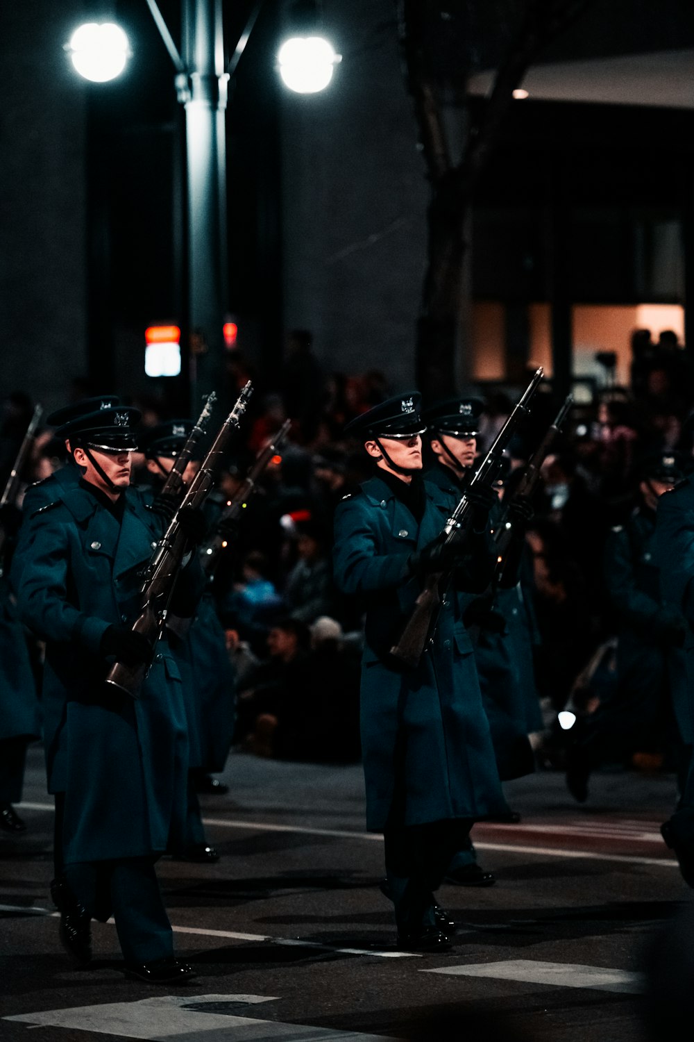 a group of men in uniform marching down a street