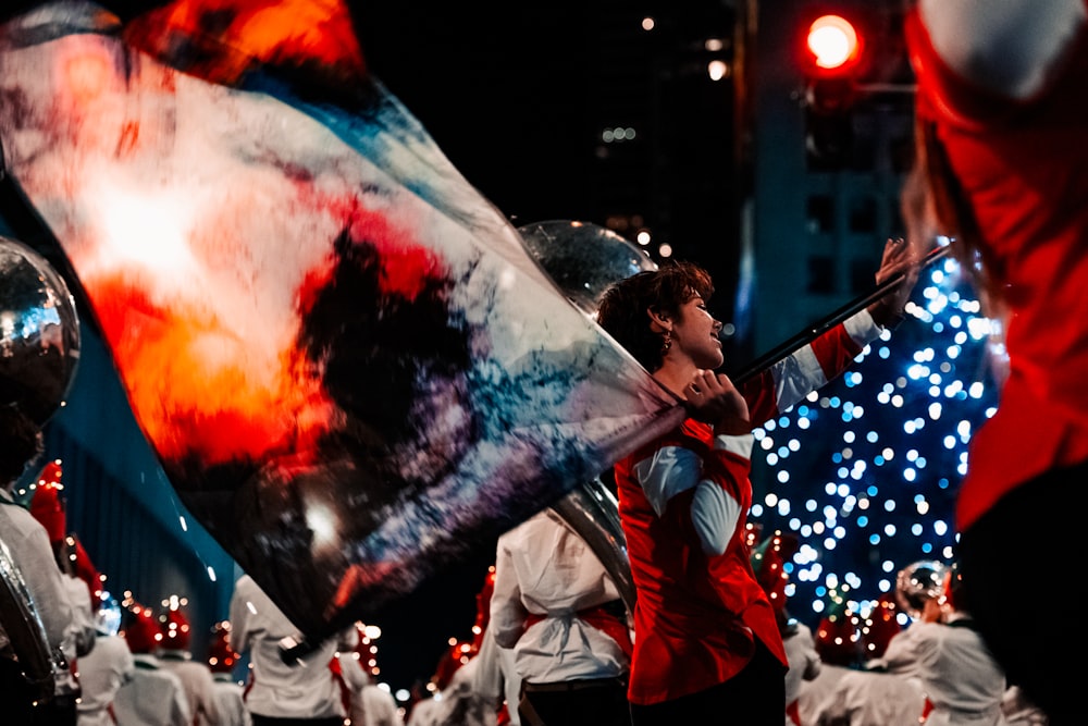 a man holding a flag in a parade