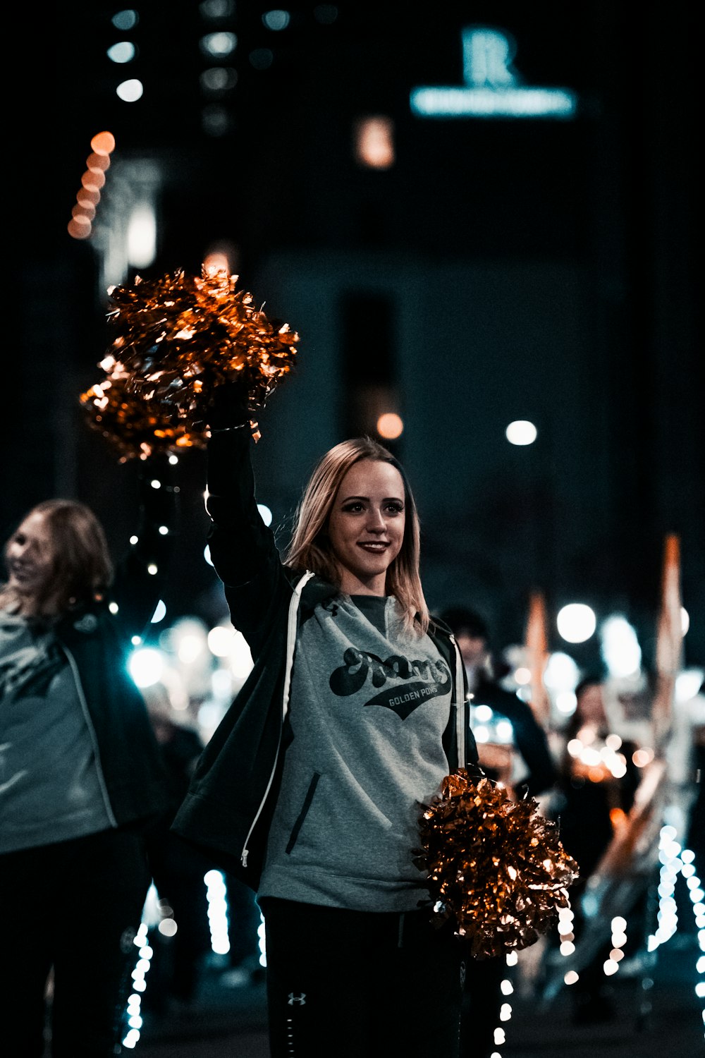 a woman holding a pom pom in her hand