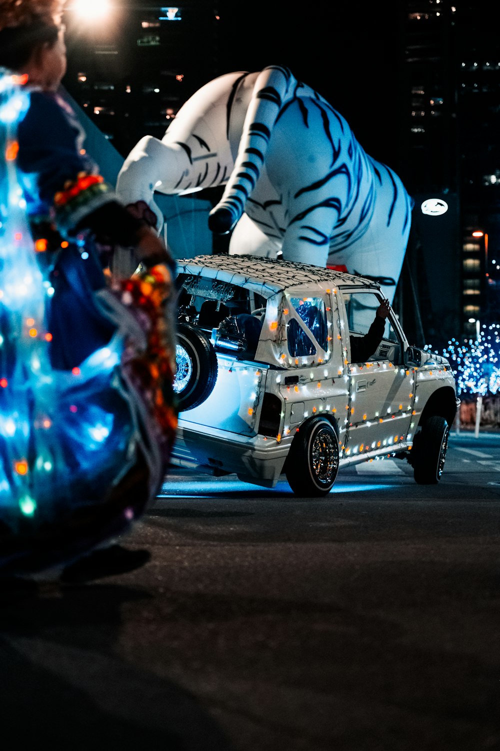 a white tiger car driving down a street at night
