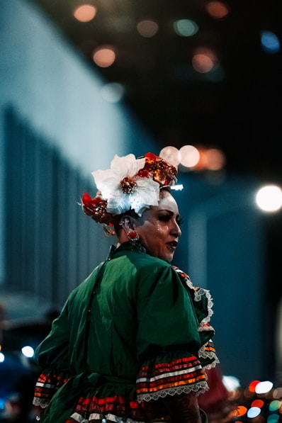 a woman in a green dress and headdress